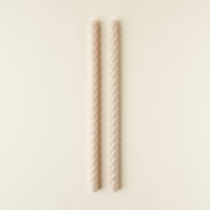 Set of two twisted taper candles in a solid color.