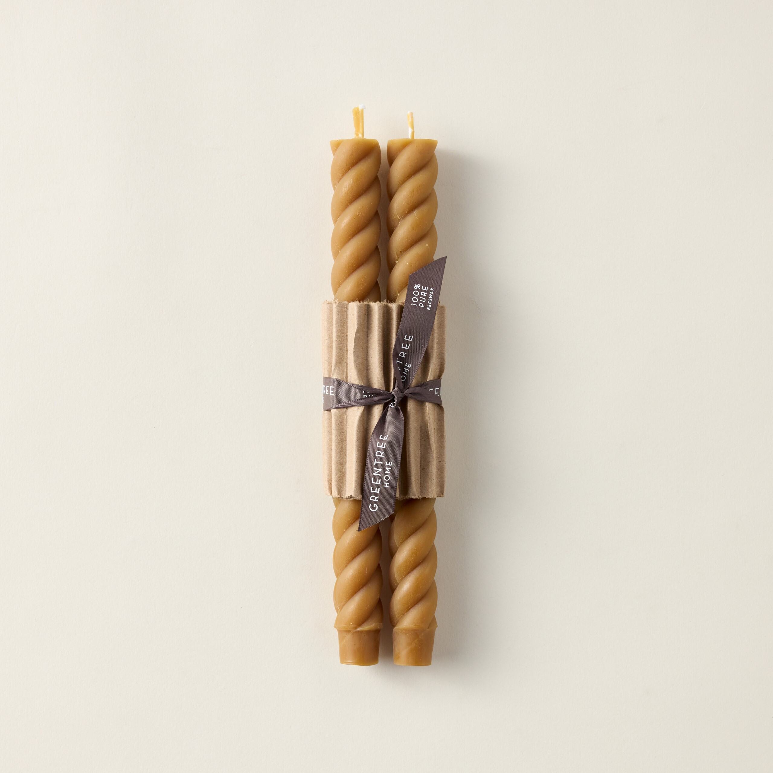 Pair of hand-poured beeswax rope taper candles with a sculptural, elegant design.