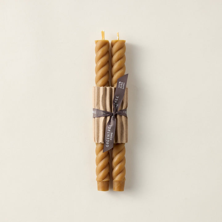 Pair of hand-poured beeswax rope taper candles with a sculptural, elegant design.