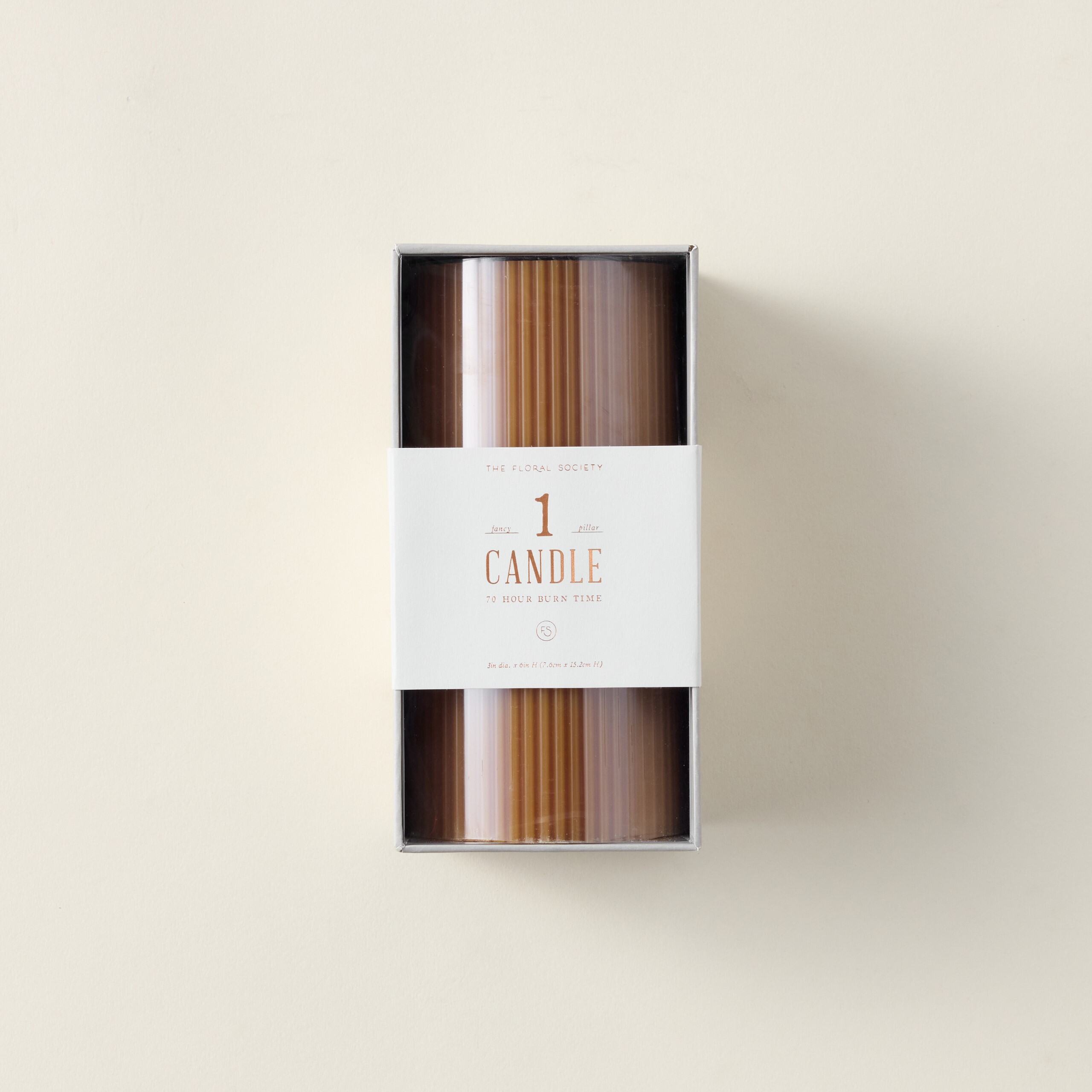 Ribbed pillar candle in a rich, solid color.