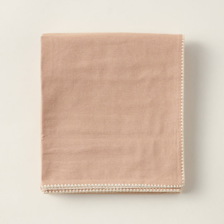 Eleanor tablecloth made of 100% cotton with embroidered trim and a nature-inspired color palette.