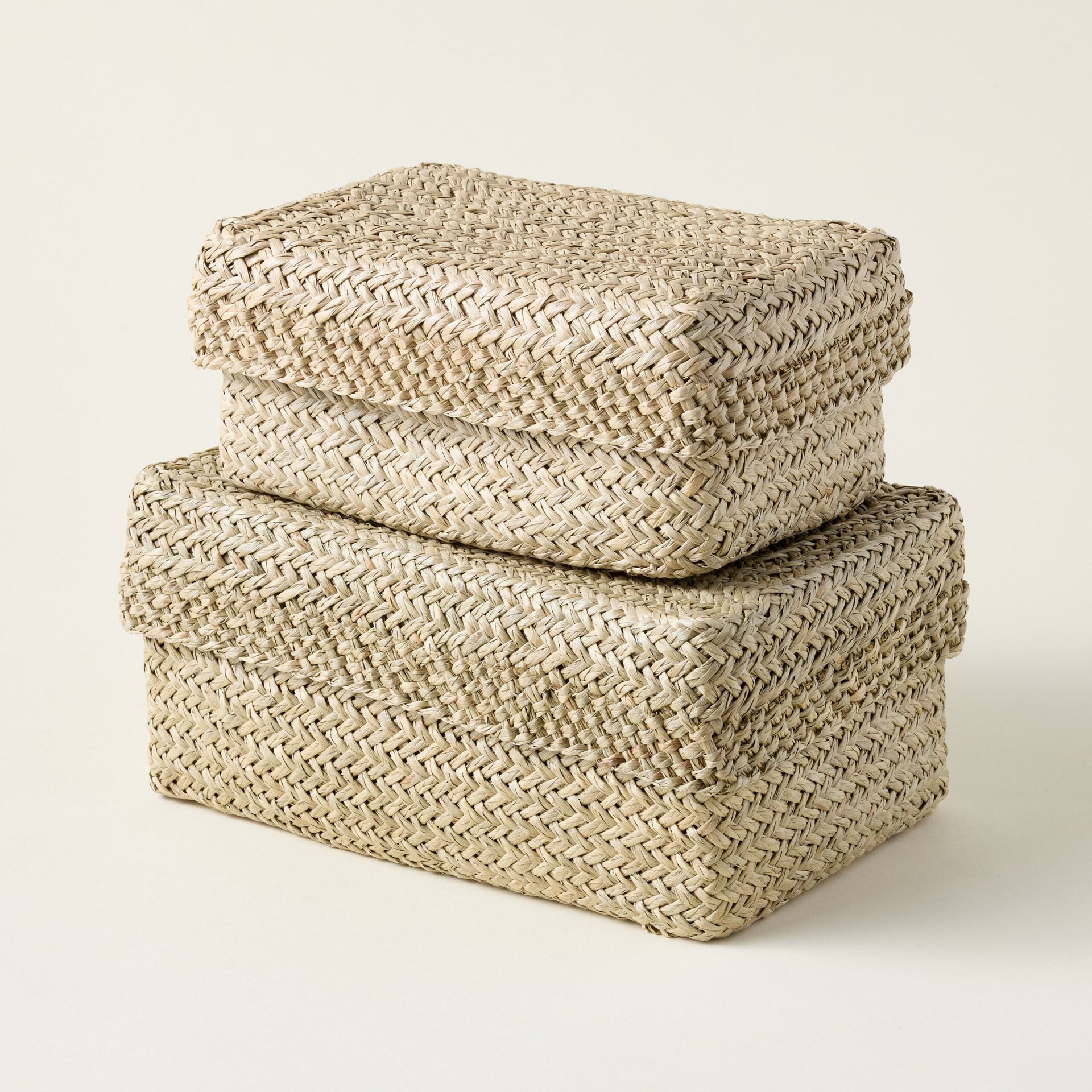 Handwoven Mendong grass storage box with a braided texture and removable lid.