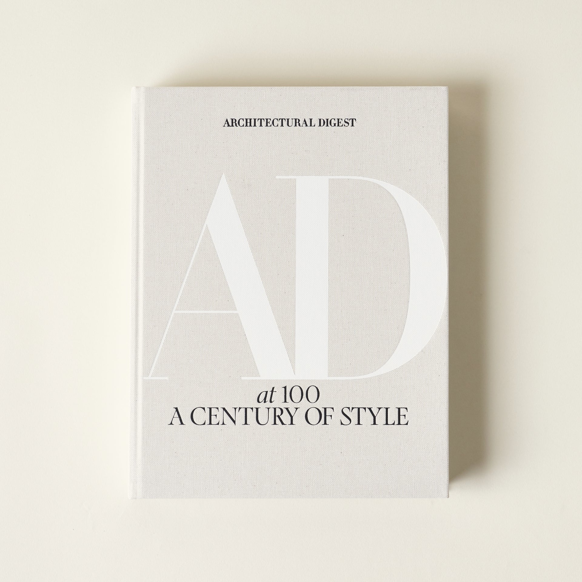 A close-up of the front cover of the Architectural Digest 100 book.