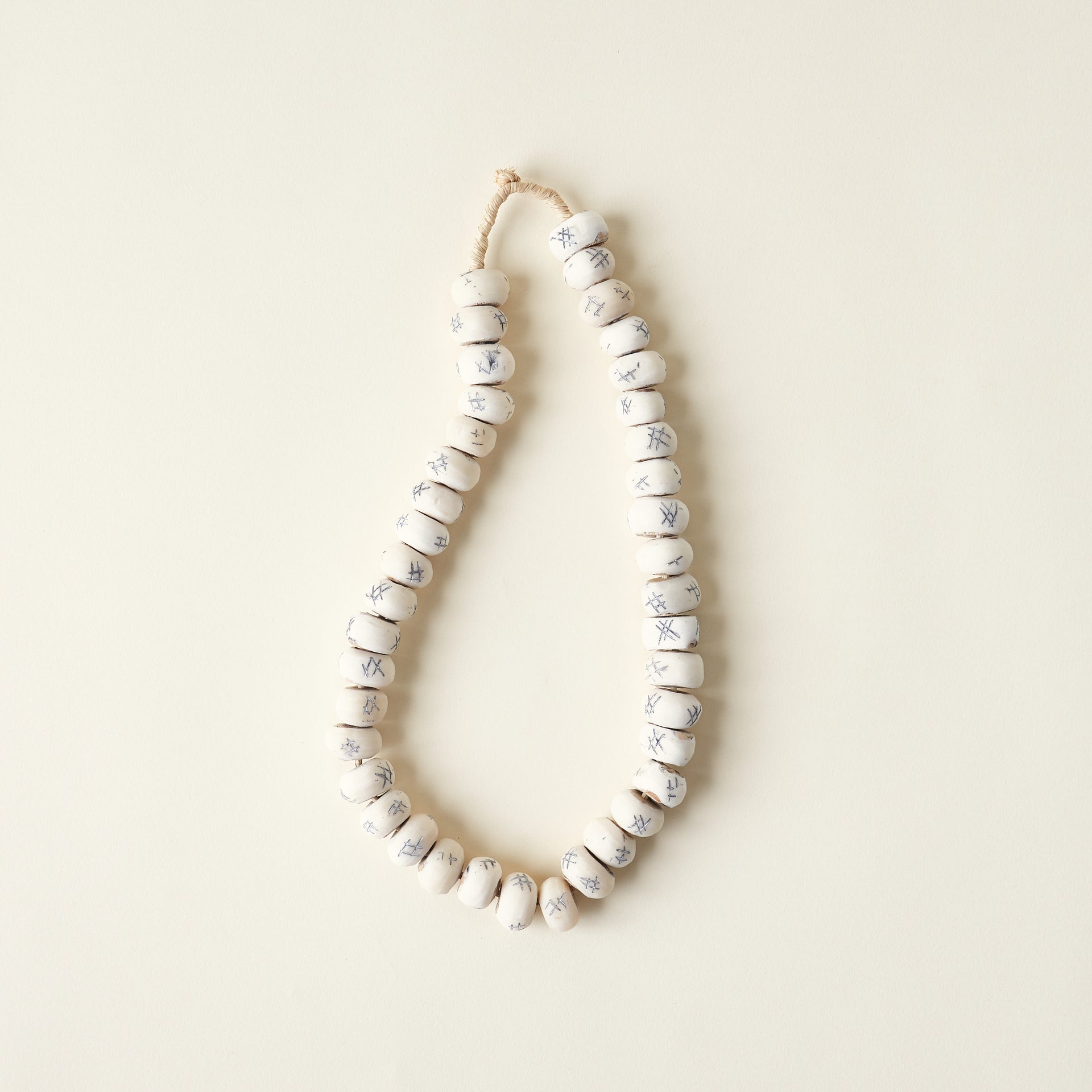 Decorative tic-tac-toe beads carved from bone.