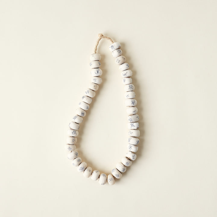 Decorative tic-tac-toe beads carved from bone.