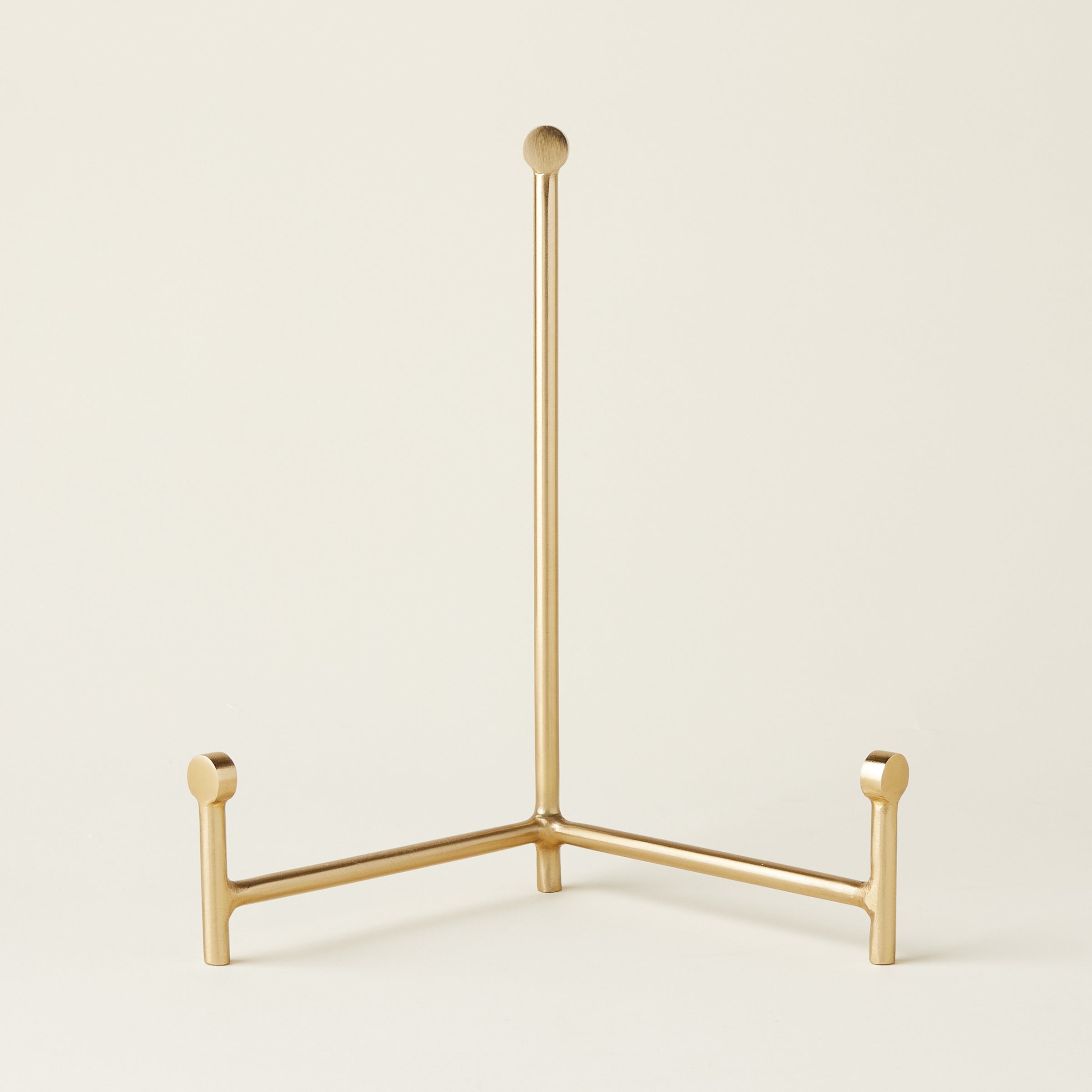 Sleek gold easel with a minimalist design.