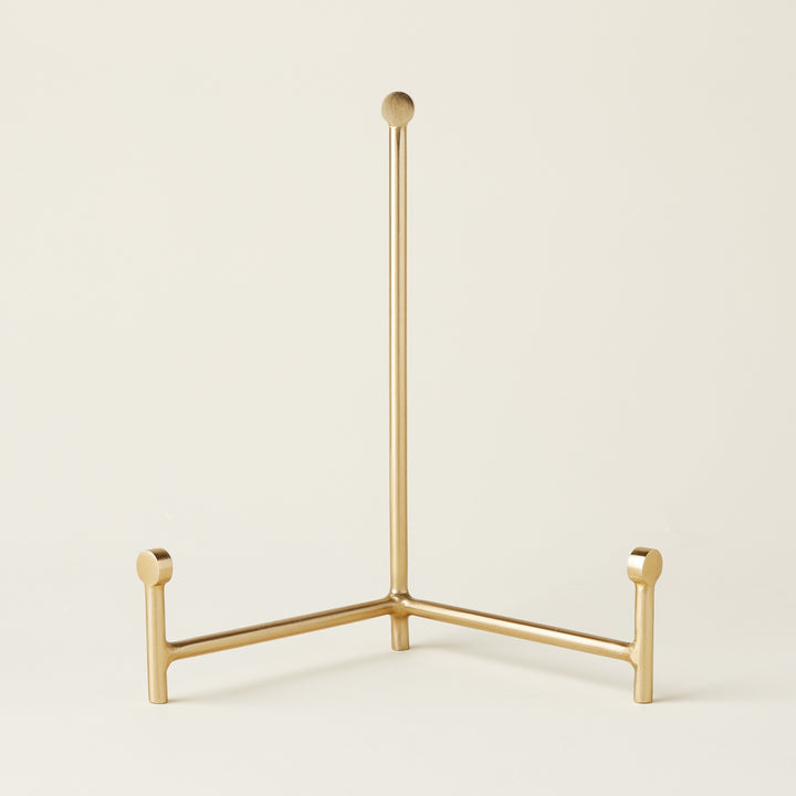 Sleek gold easel with a minimalist design.