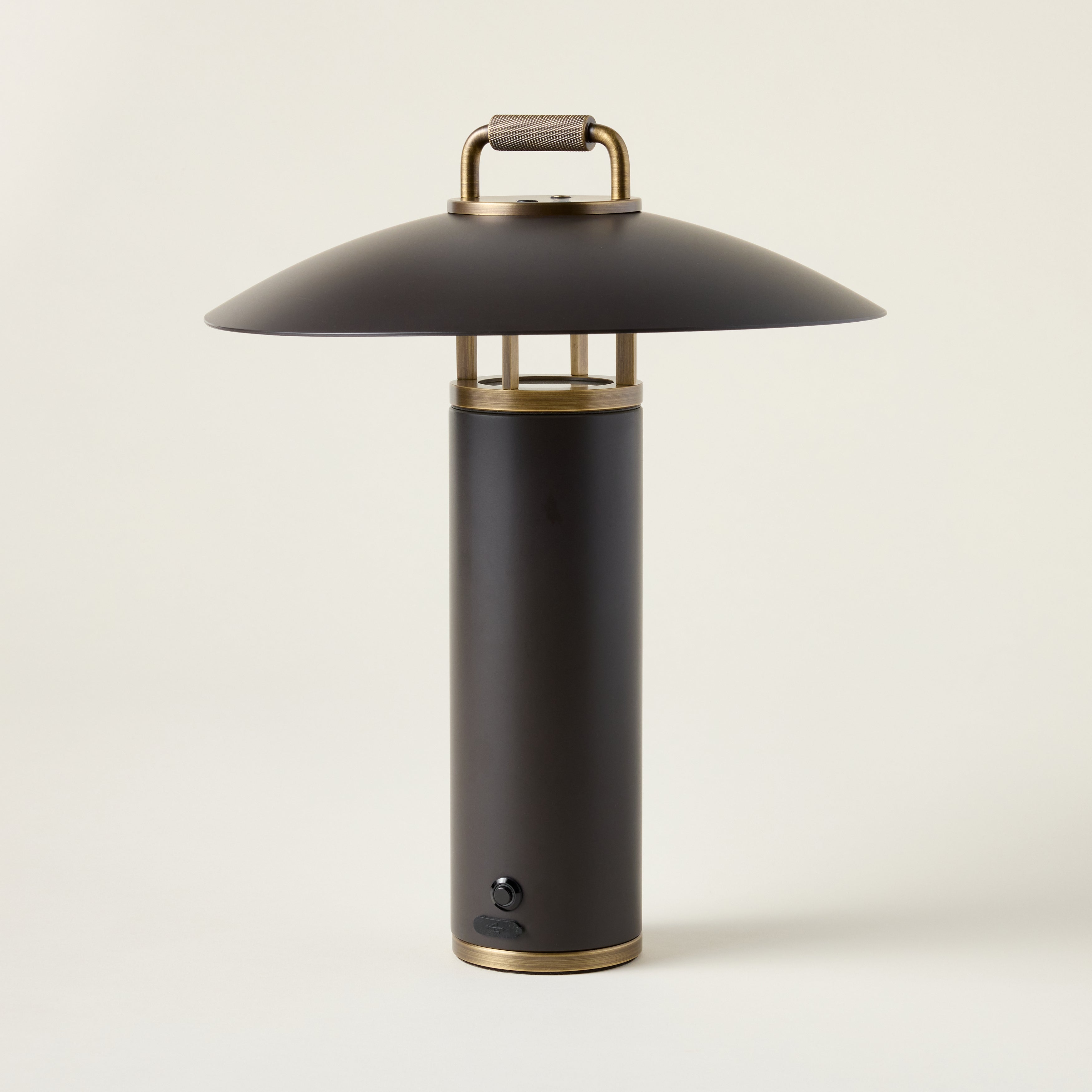 Birk Exterior rechargeable table lamp with a Bronze finish and Patina Brass accents.