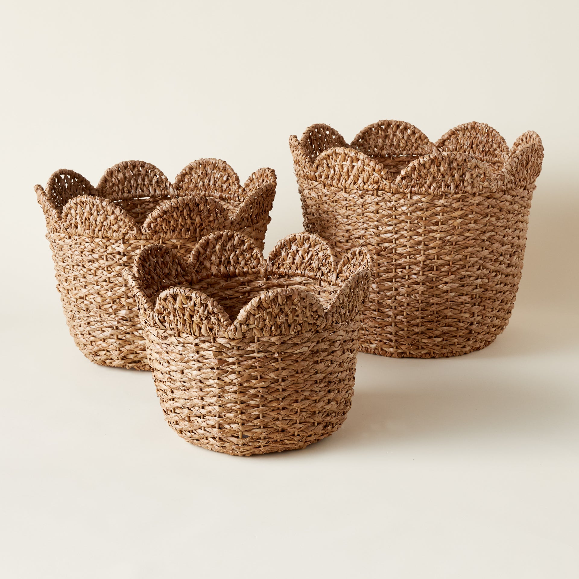Handwoven scalloped basket with a natural braided texture and a unique decorative edge.