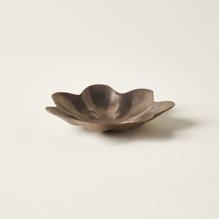 Hand-forged brass dish in the shape of a flower.