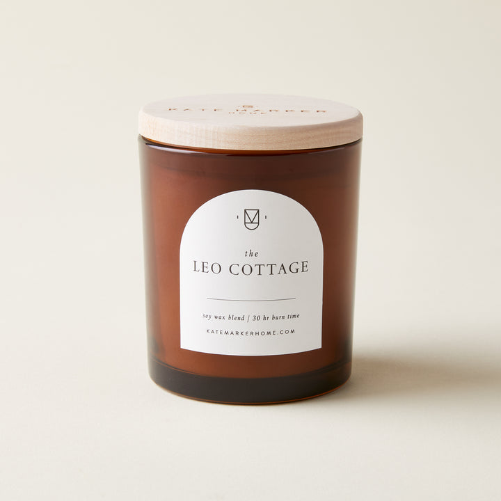 "The Leo Cottage" candle with a warm, comforting scent inspired by a century-old cottage.