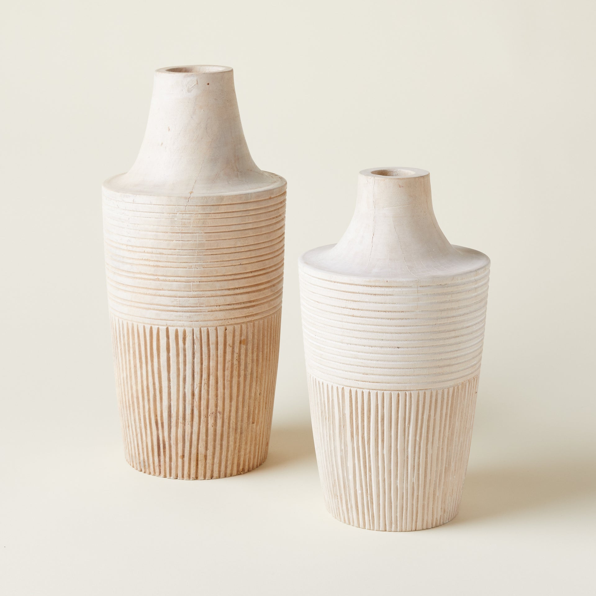 Set of two hand-carved mango wood vases, shown in different sizes.