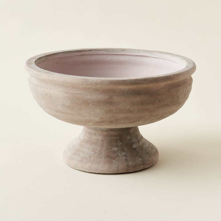 Muted pink compote bowl with a sculptural design.