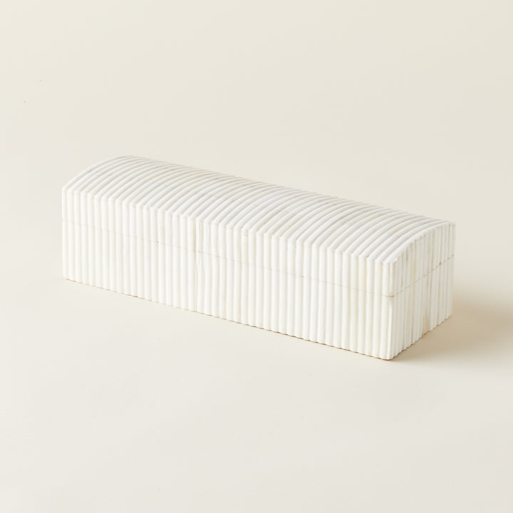 A decorative box with a curved dome lid, handcrafted from bone with a subtle texture.