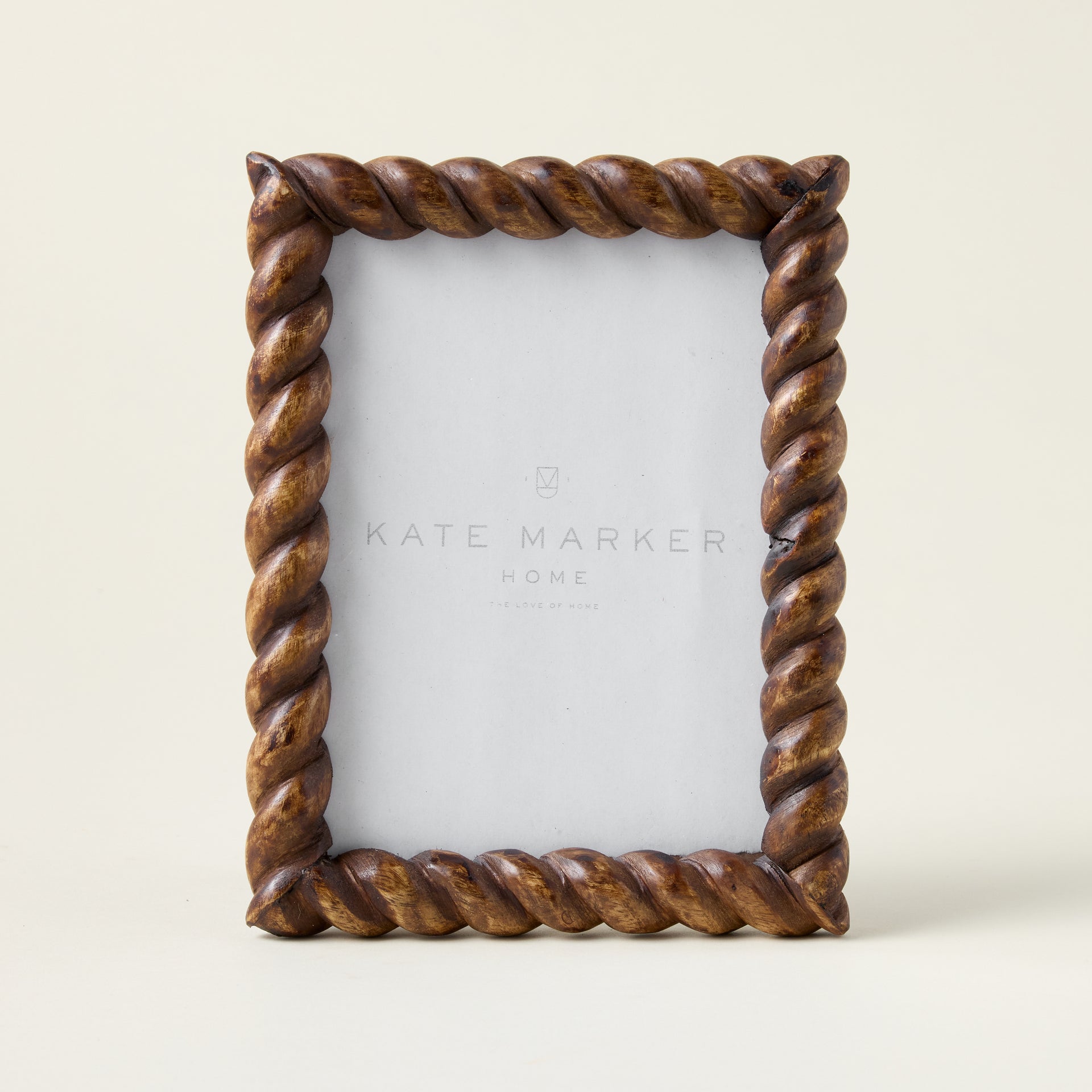 Hand-carved mango wood photo frame with intricate twist detailing and a dark, refined finish.