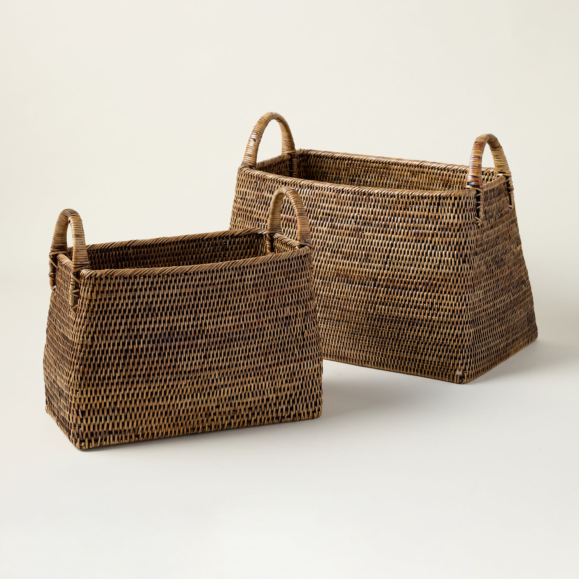 Handcrafted dark rattan basket with a tight, artisanal weave and a warm brown finish.