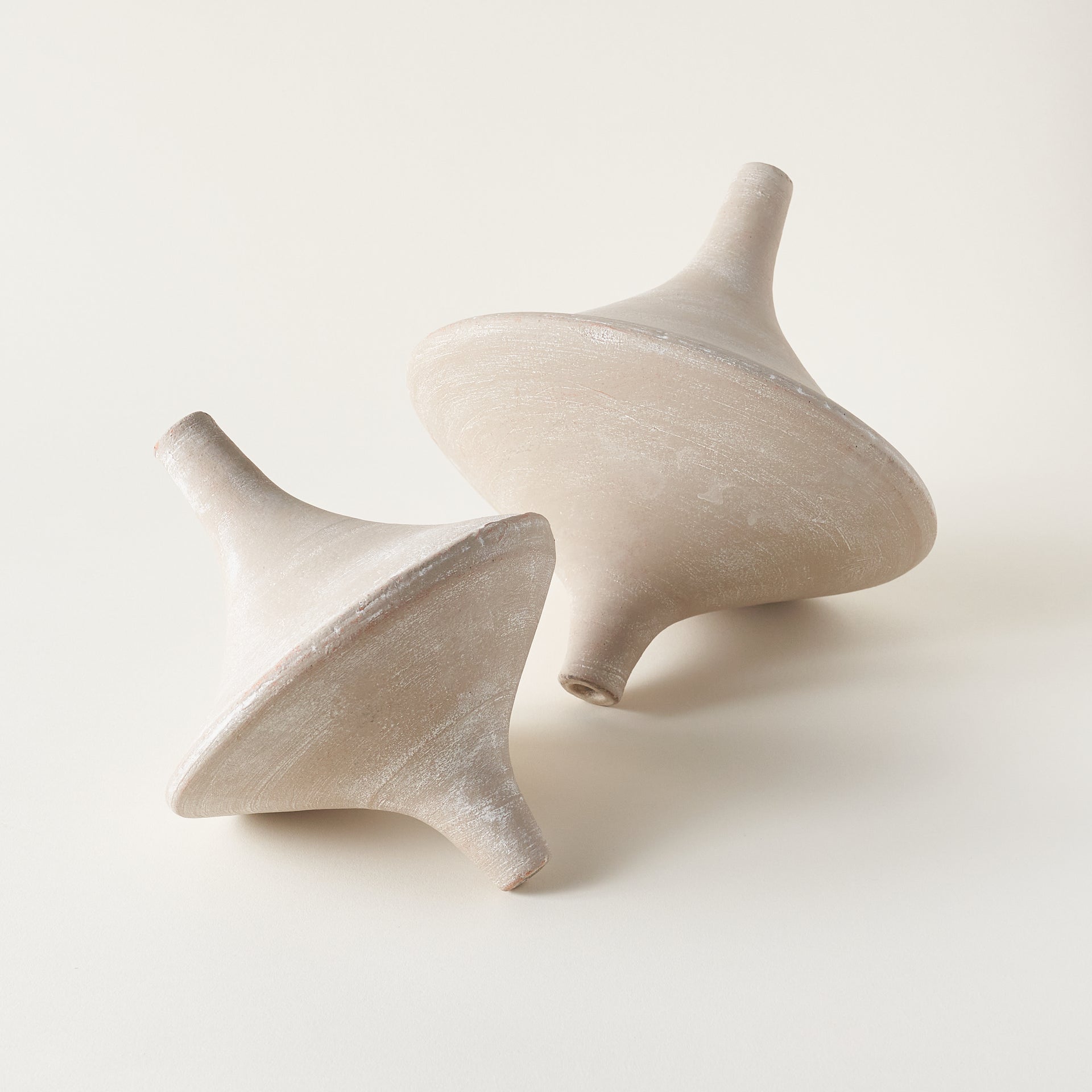 Decorative clay top with a gray washed finish, shown on a coffee table.