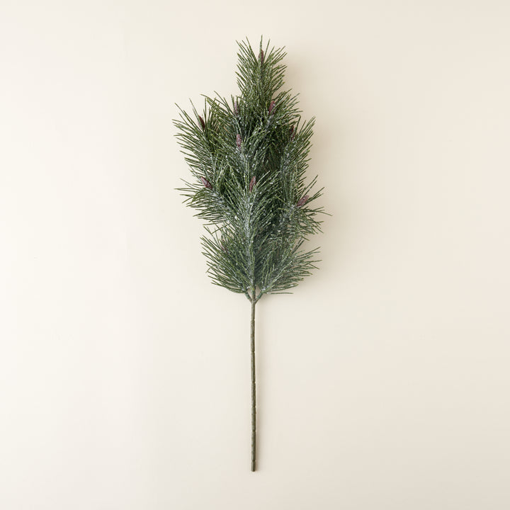 A faux pine branch with a white, frost-like finish.
