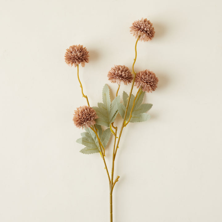 A close-up of the delicate petals and intricate texture of the faux kiku flower.