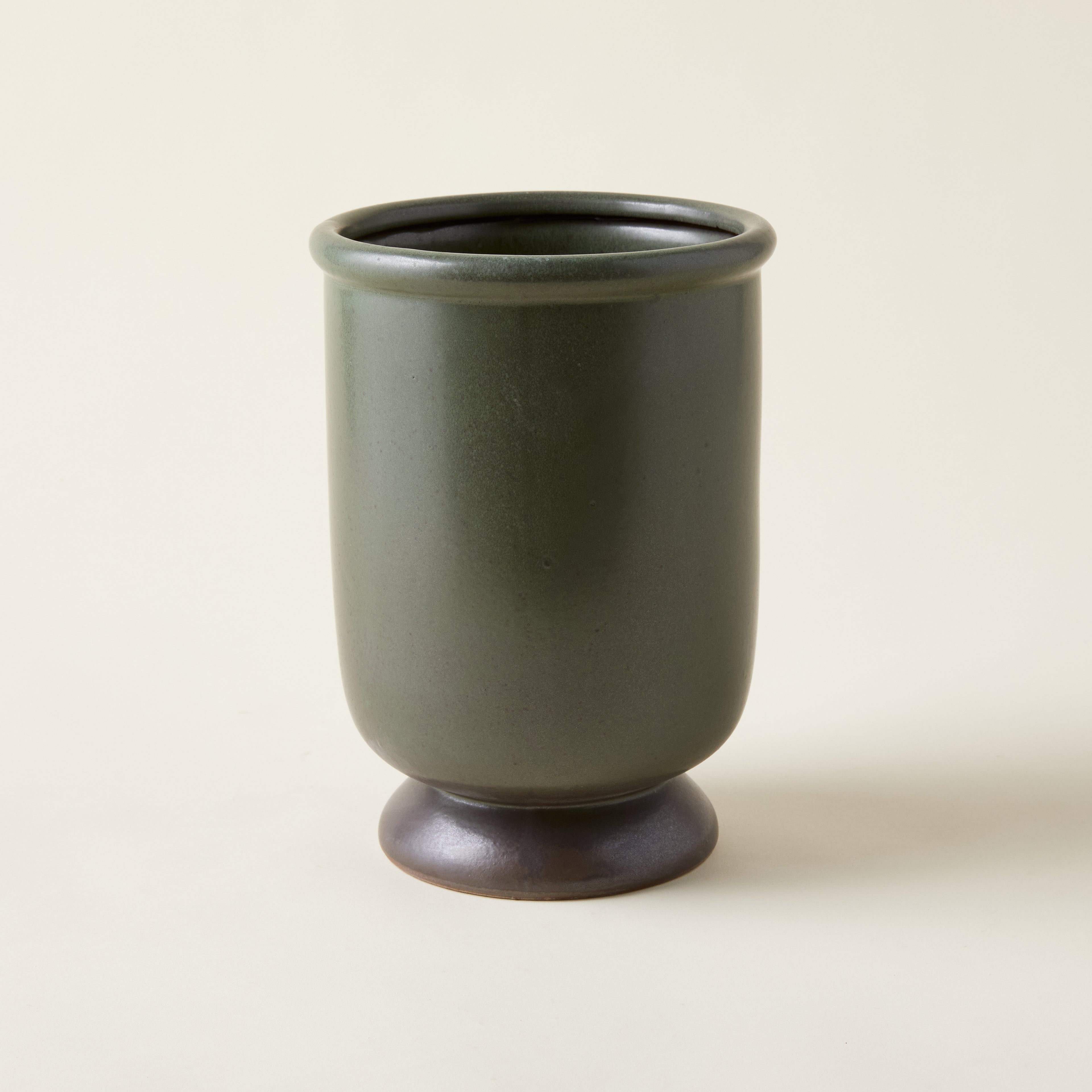 Handcrafted Sydney vase with an organic round shape and a unique, earthy green reactive glaze.