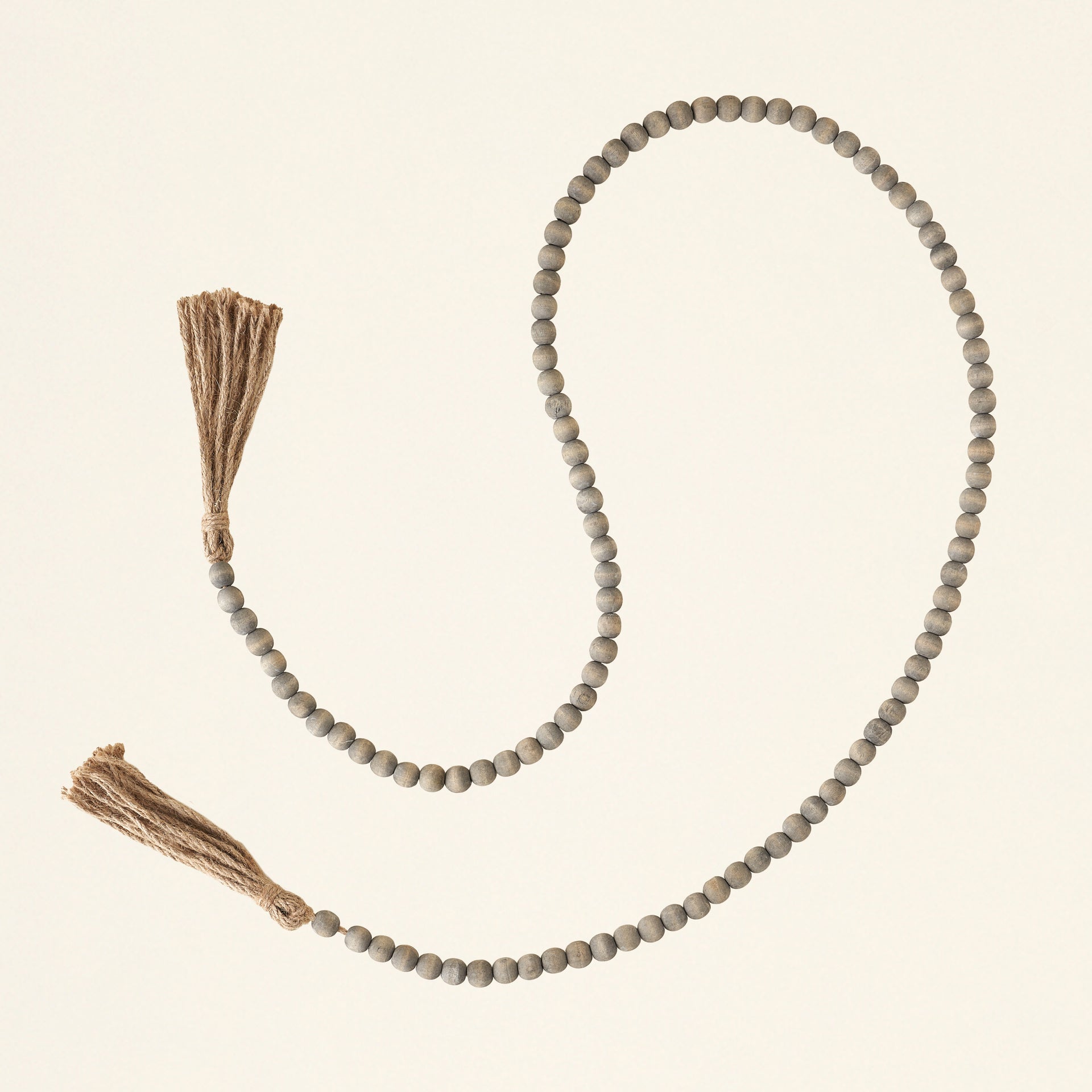 Grey jute and wood bead garland with tassels.