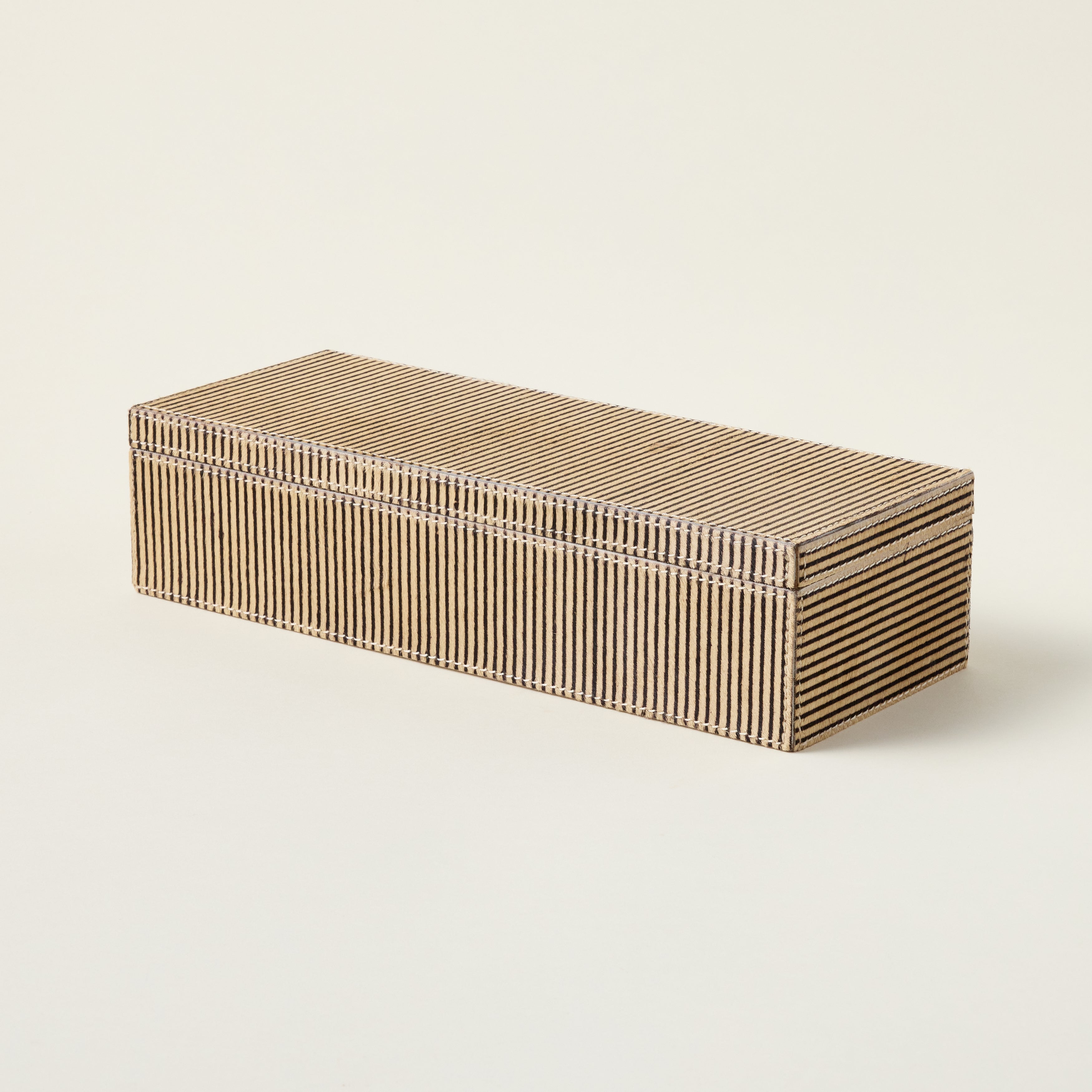 Handcrafted leather box made from genuine hair-on-hide material for decorative storage.