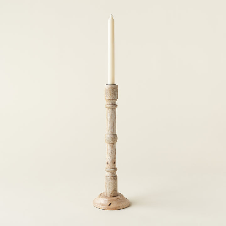 A hand-carved mango wood taper holder.
