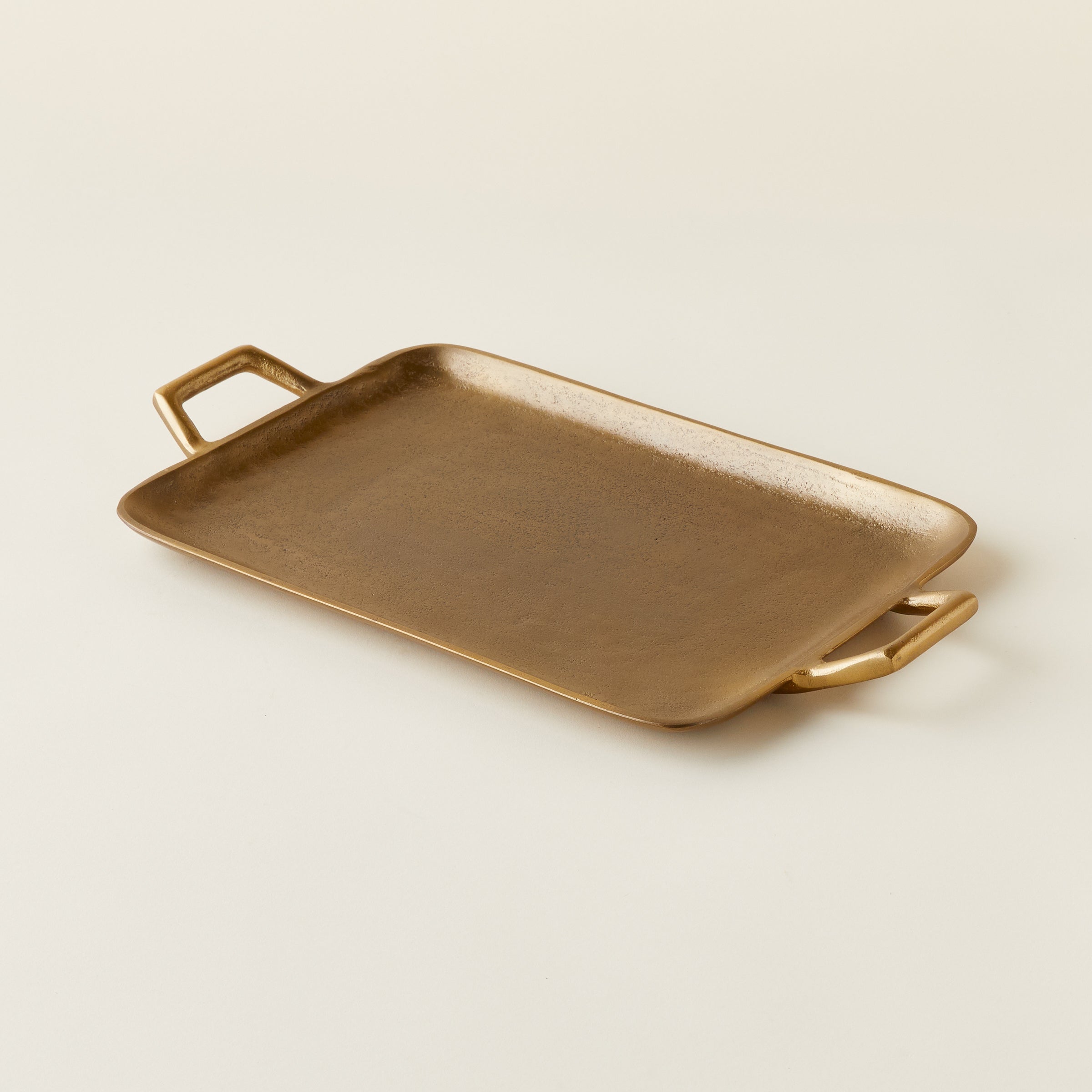 Brass metal tray with handles.