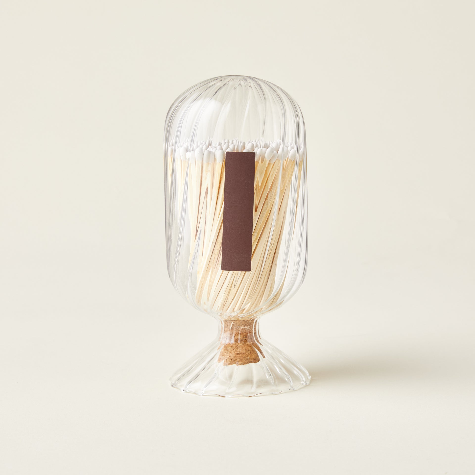 Glass dome filled with matches and a strike-on-bottle flint.