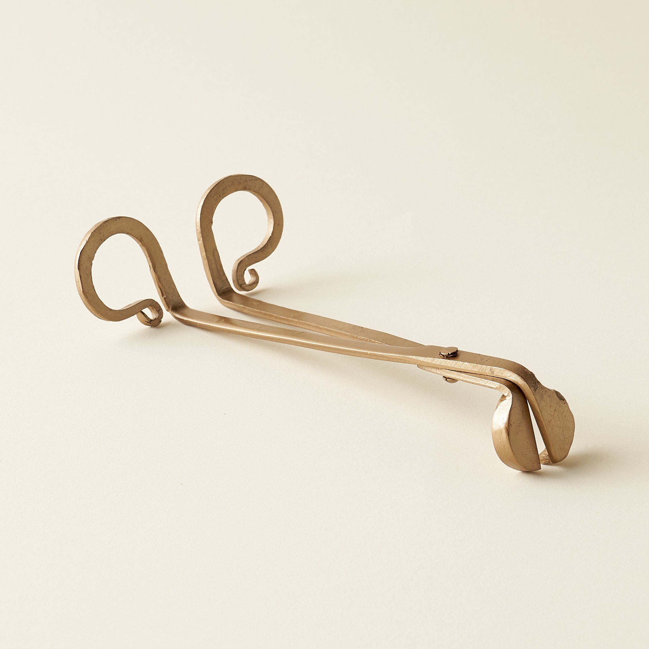 Metal candle wick trimmer with a simple, sophisticated design.
