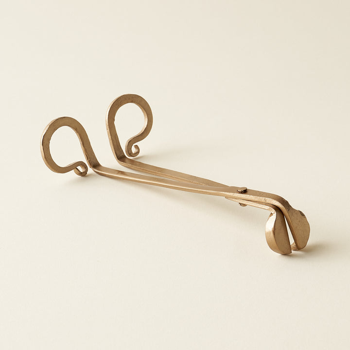 Metal candle wick trimmer with a simple, sophisticated design.