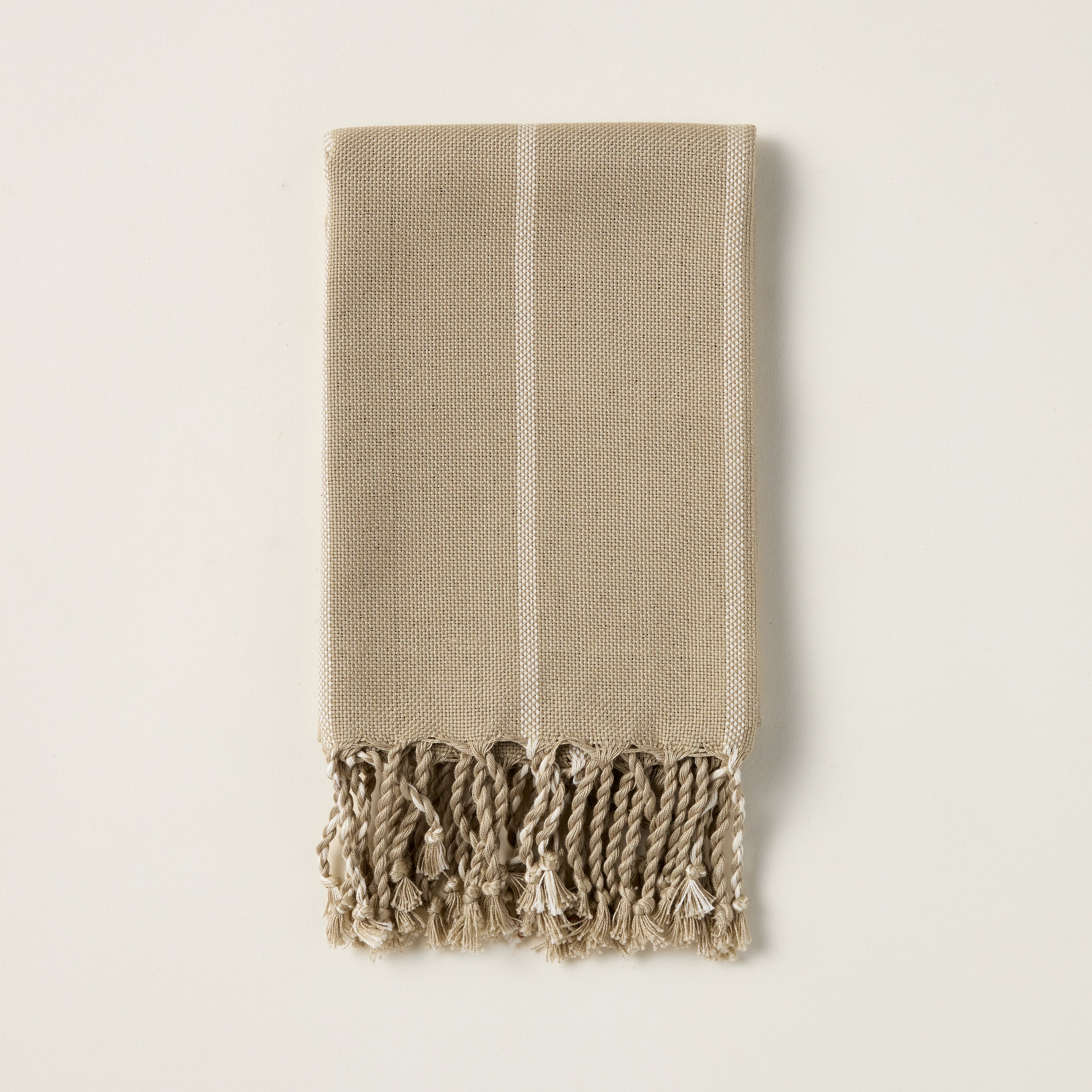 June hand towel with a vertical striped pattern in yarn-dyed taupe and green, and a natural fringe.