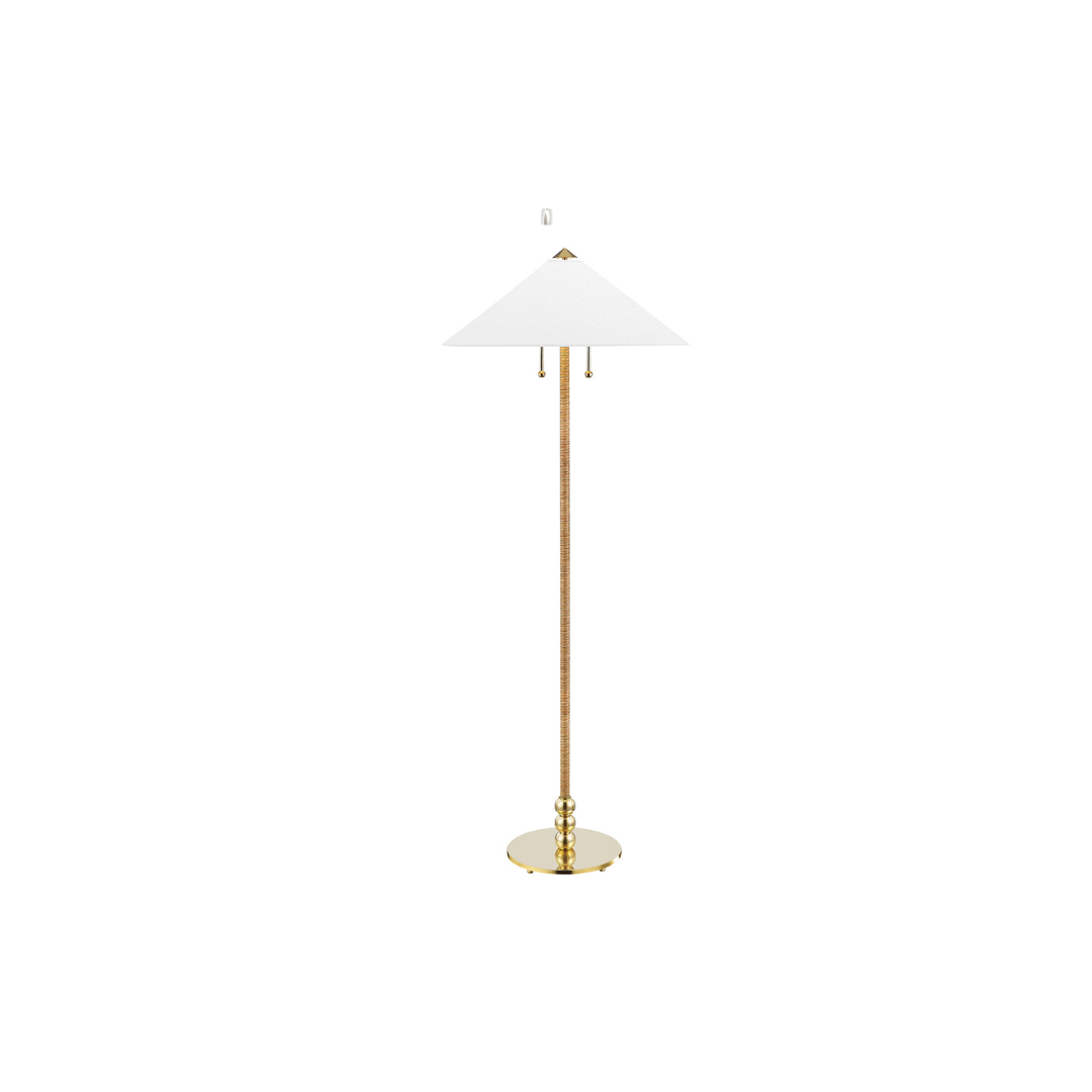 A floor lamp with a shade made from rattan and an aged brass base.