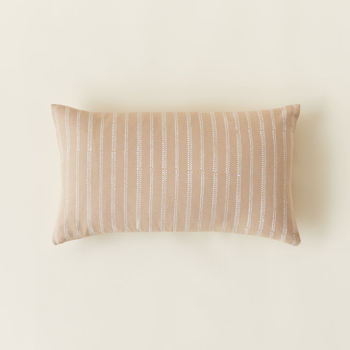 A handwoven lumbar pillow cover with a broken stripe pattern in soft, textured colors.