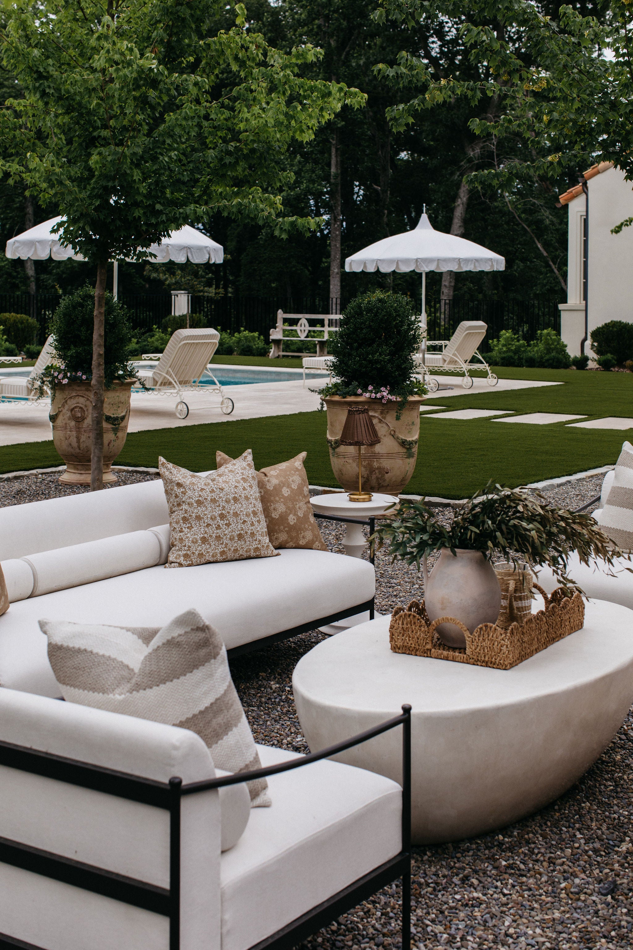 A white agate stone coffee table styled on a patio or deck with outdoor seating.