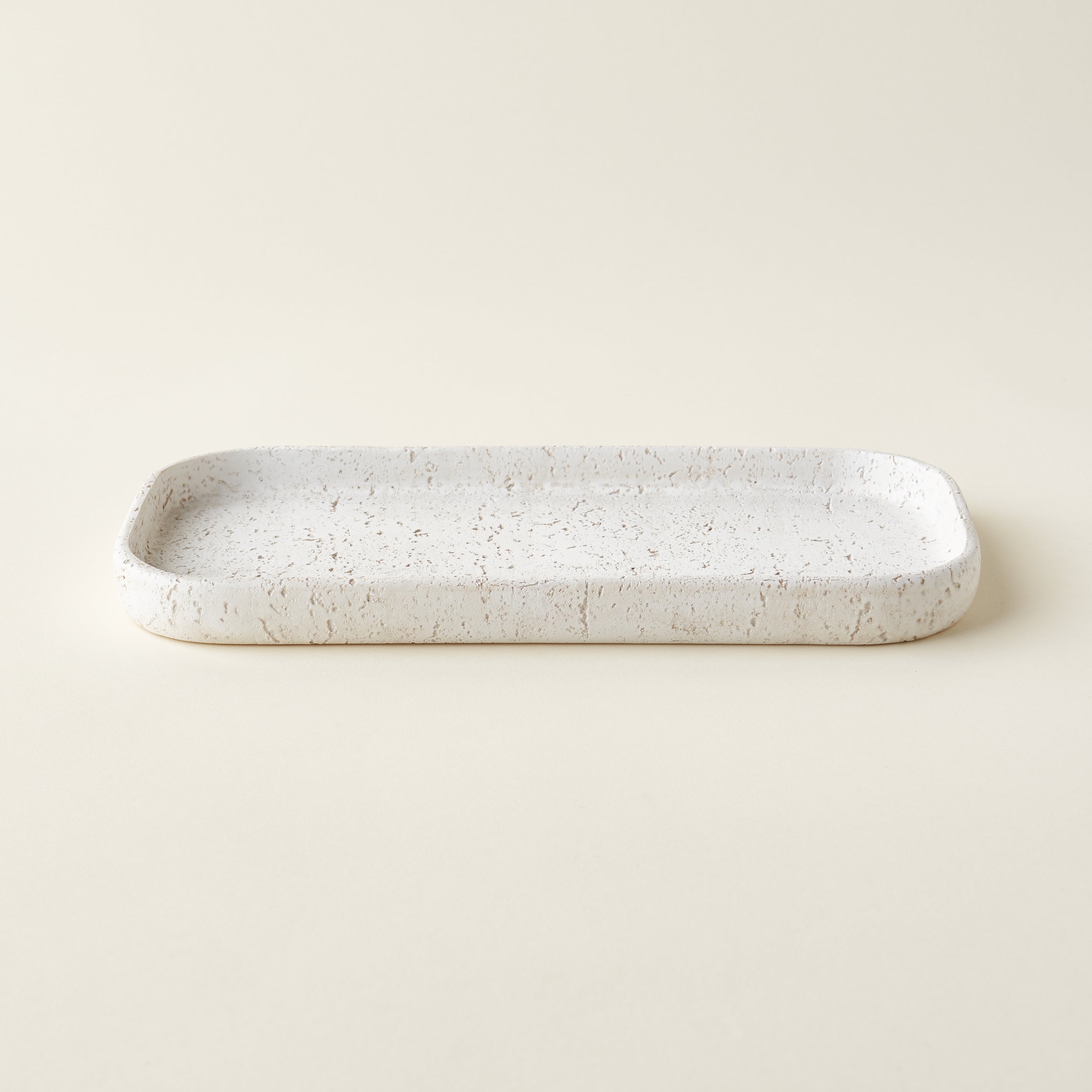 A rectangular tray made of durable resin with a gray limestone-like texture.
