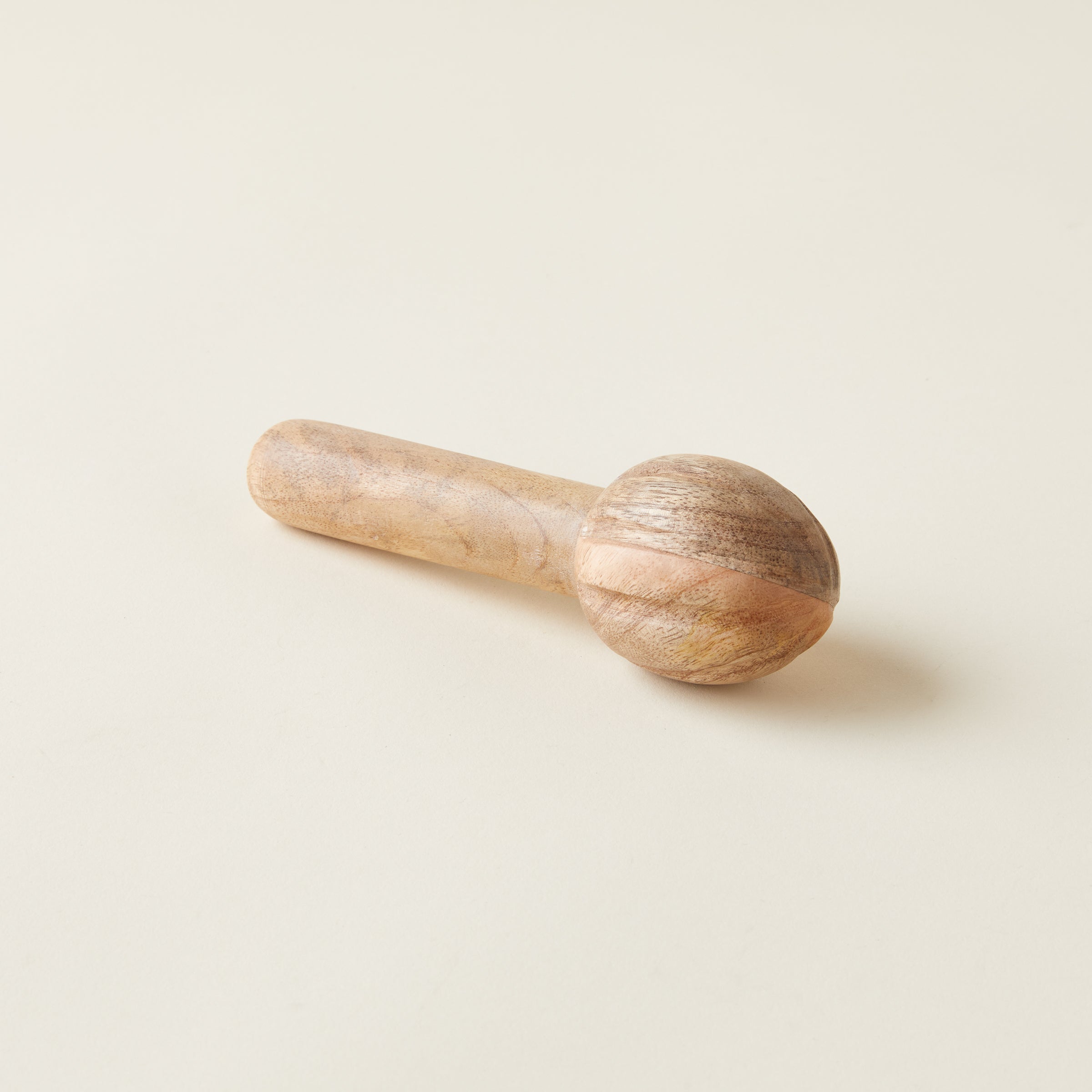 Mango wood citrus reamer, a natural and ergonomic juicing tool.