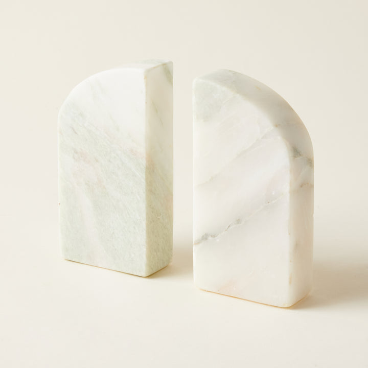 A set of two decorative half-arch shaped bookends carved from polished green marble.