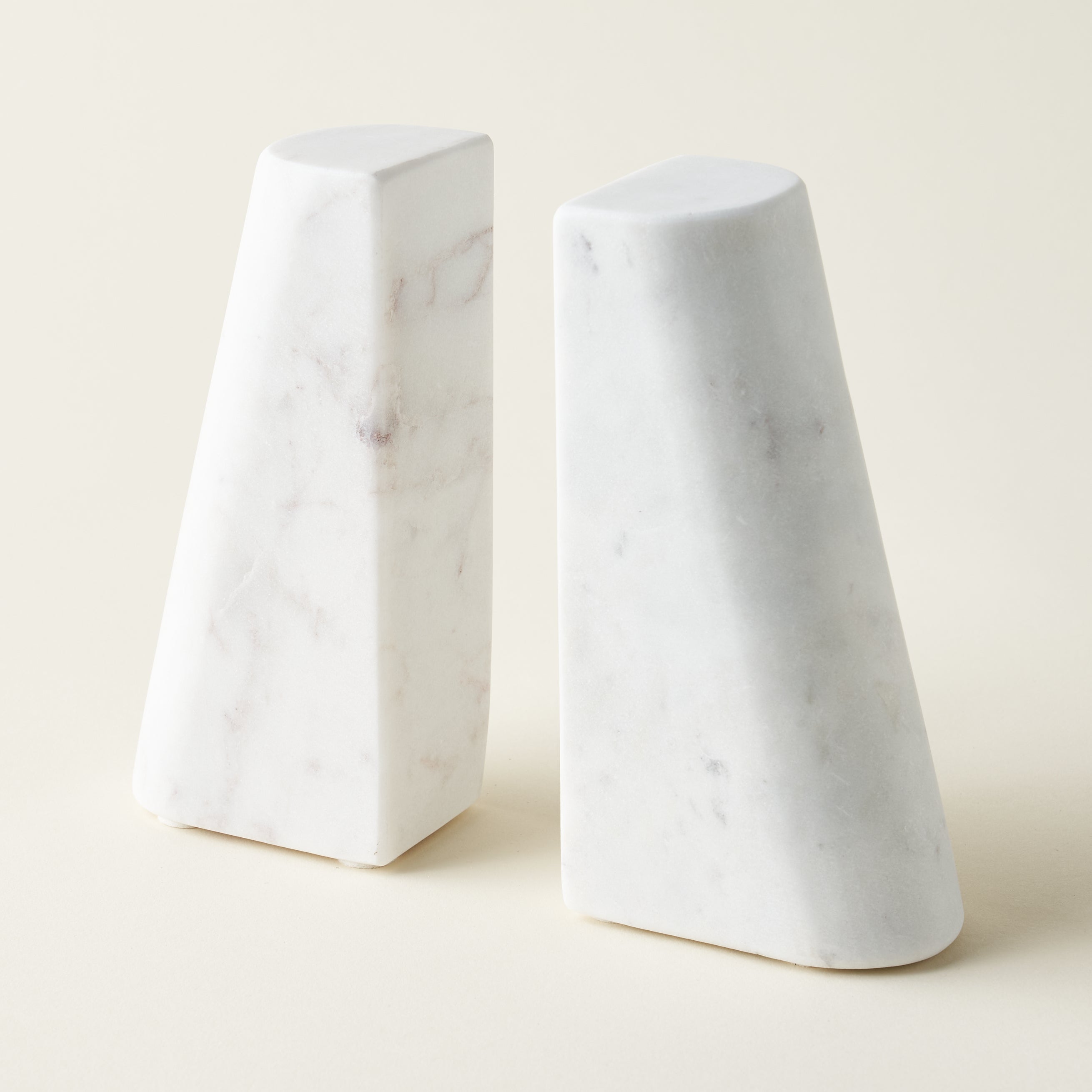 White marble bookends for a bookshelf.