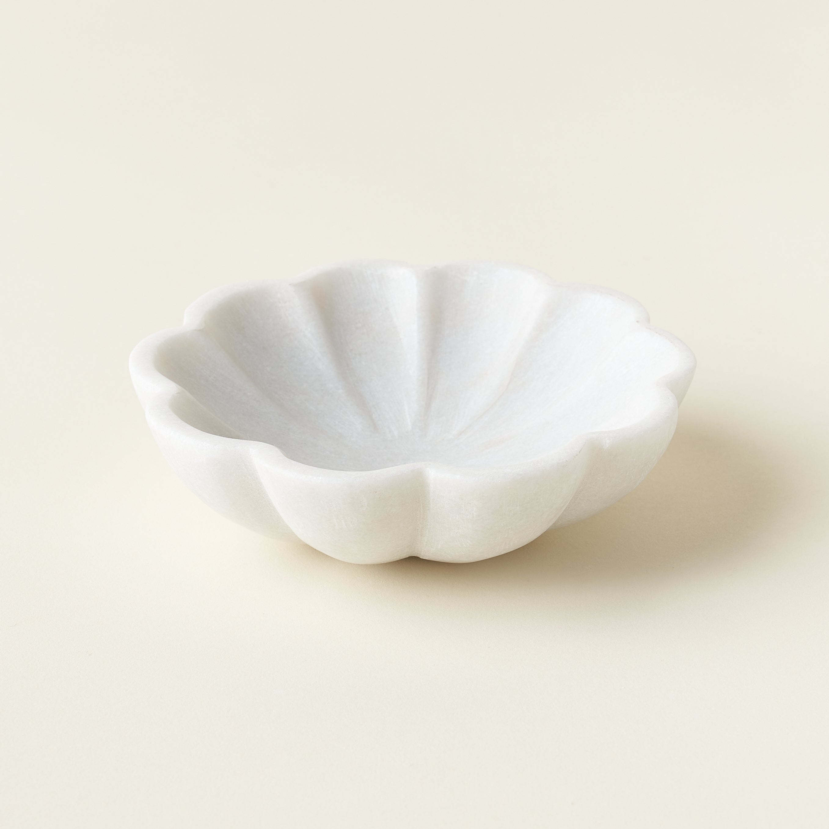 Sculptural marble flower dish for serving or decor.