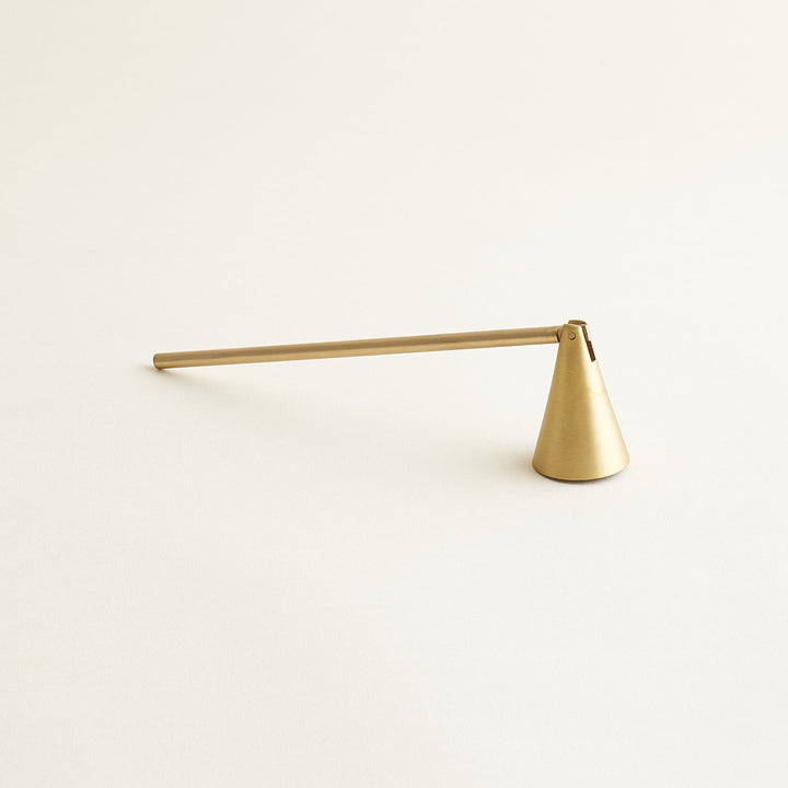 Sleek brass candle snuffer with a hinged cone.