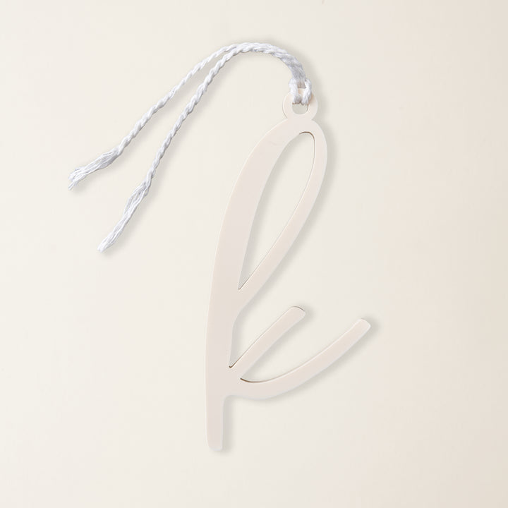 A clear acrylic Christmas ornament with a single monogram letter.