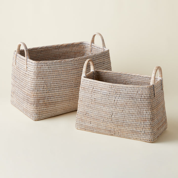 A handwoven natural rattan basket with a tight weave and whitewash finish.