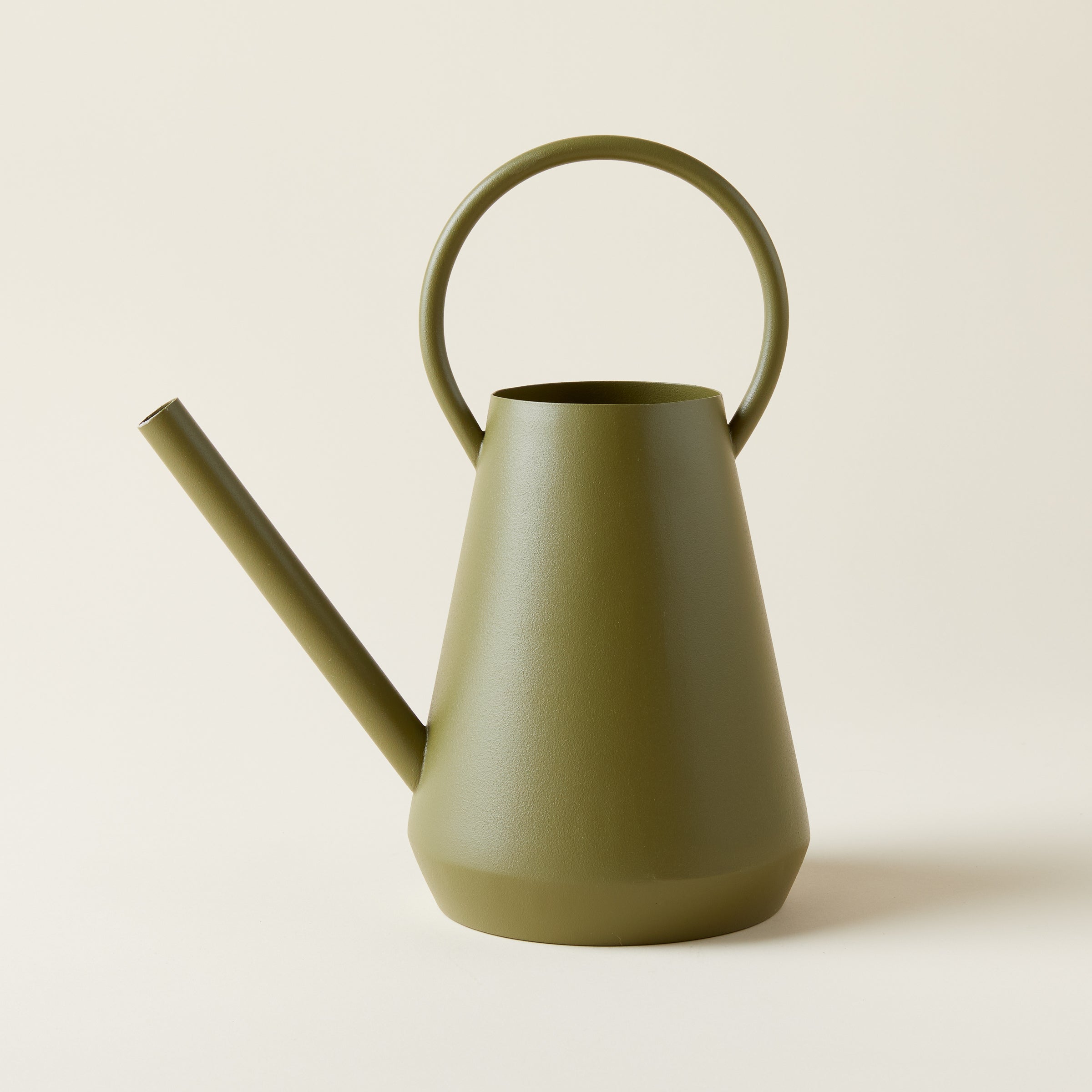 Paisley Watering Can, textured iron in a matte green finish, holding water.