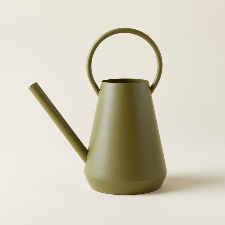 Paisley Watering Can, textured iron in a matte green finish, holding water.