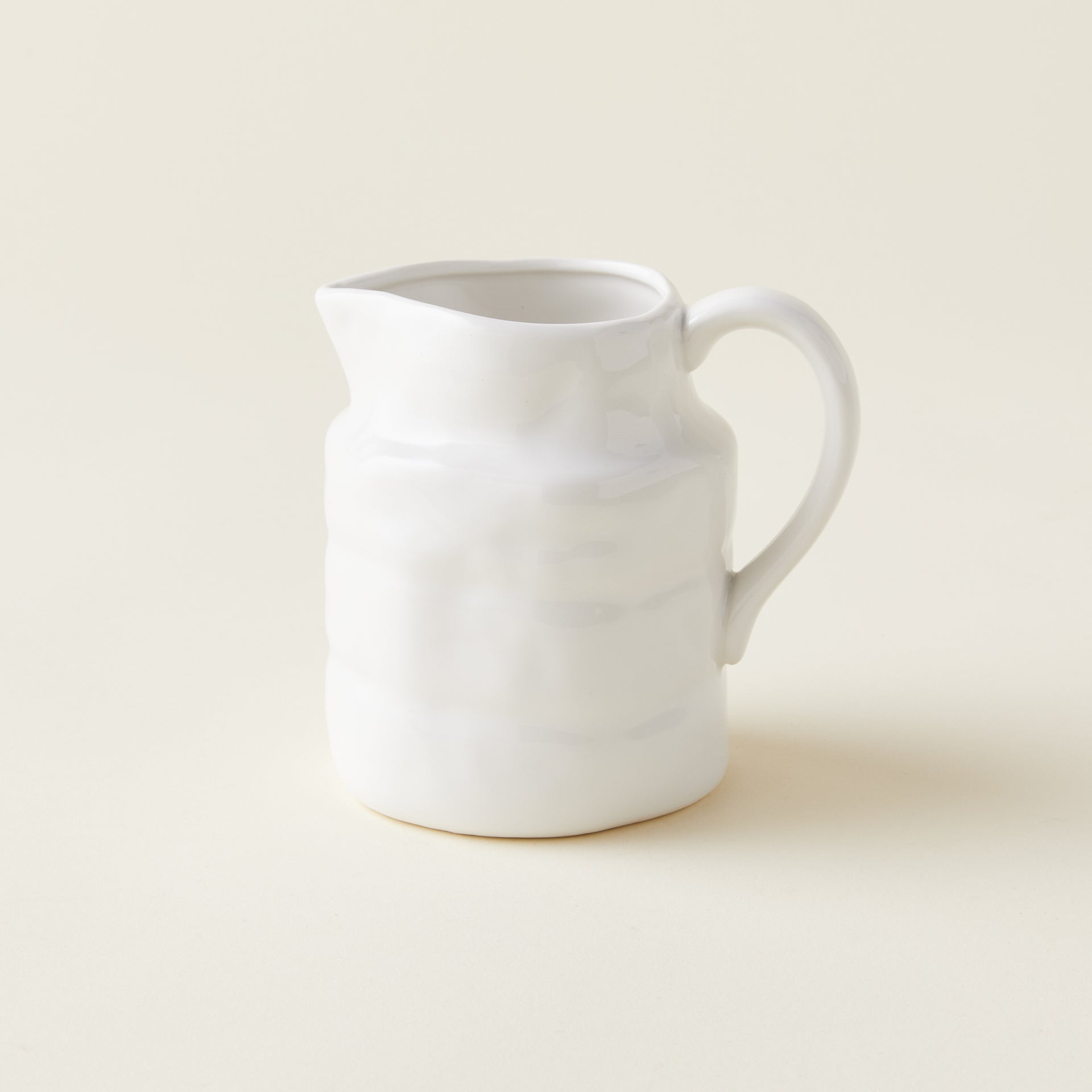 Petite stoneware pitcher with a vintage-inspired design.