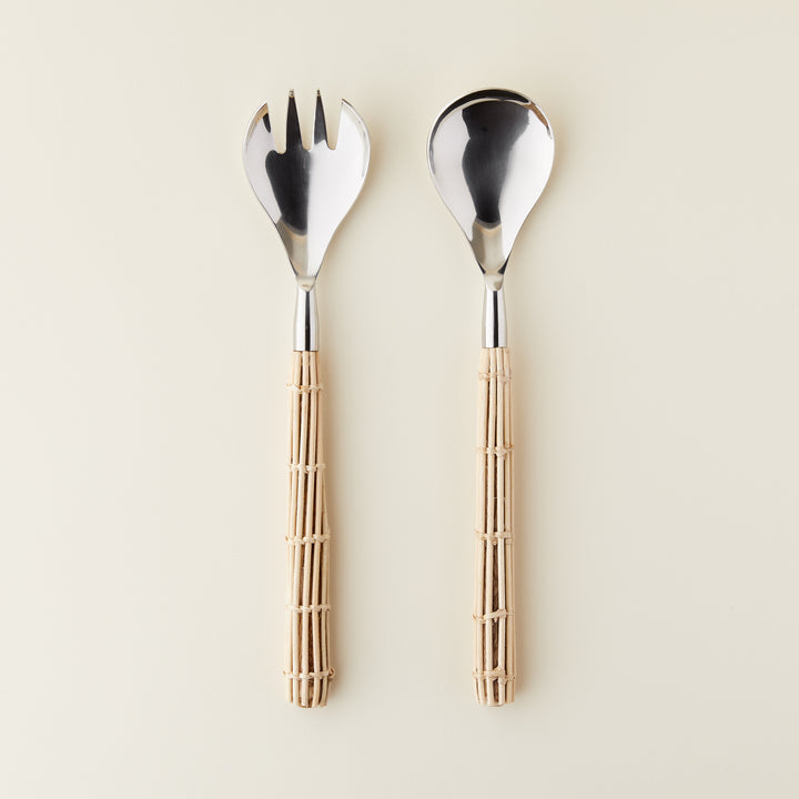 Luxury rattan salad servers with stainless steel ends and woven rattan handles.