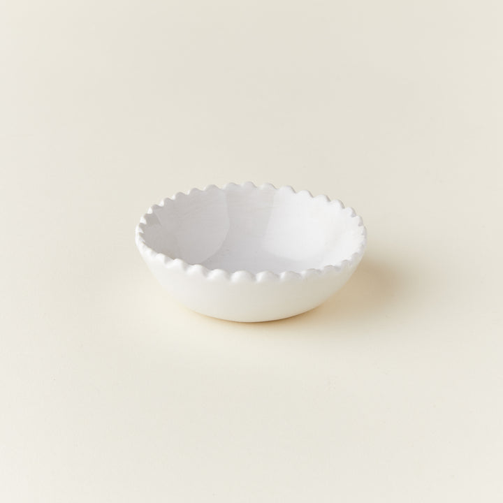A small decorative bowl with a ruffled, scalloped edge.