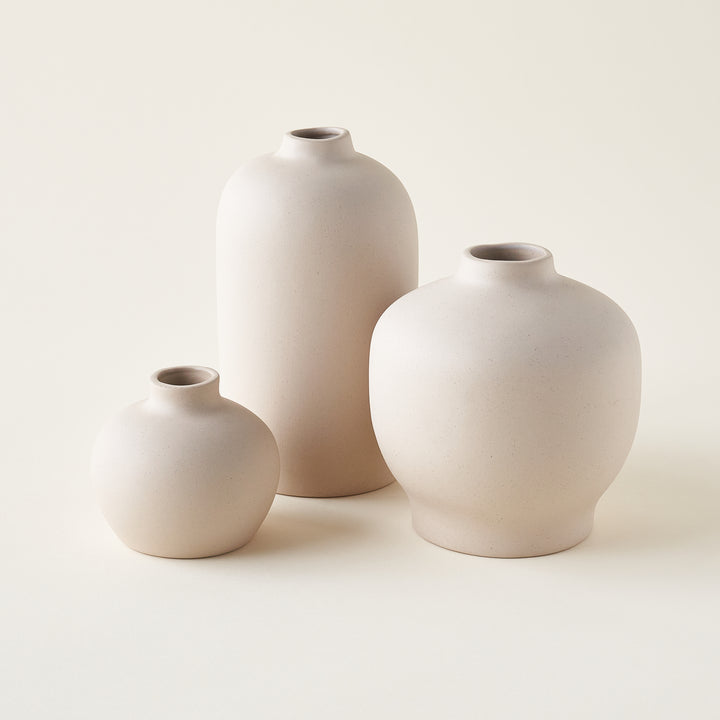 Set of three vases with organic, sculptural shapes in varying sizes.
