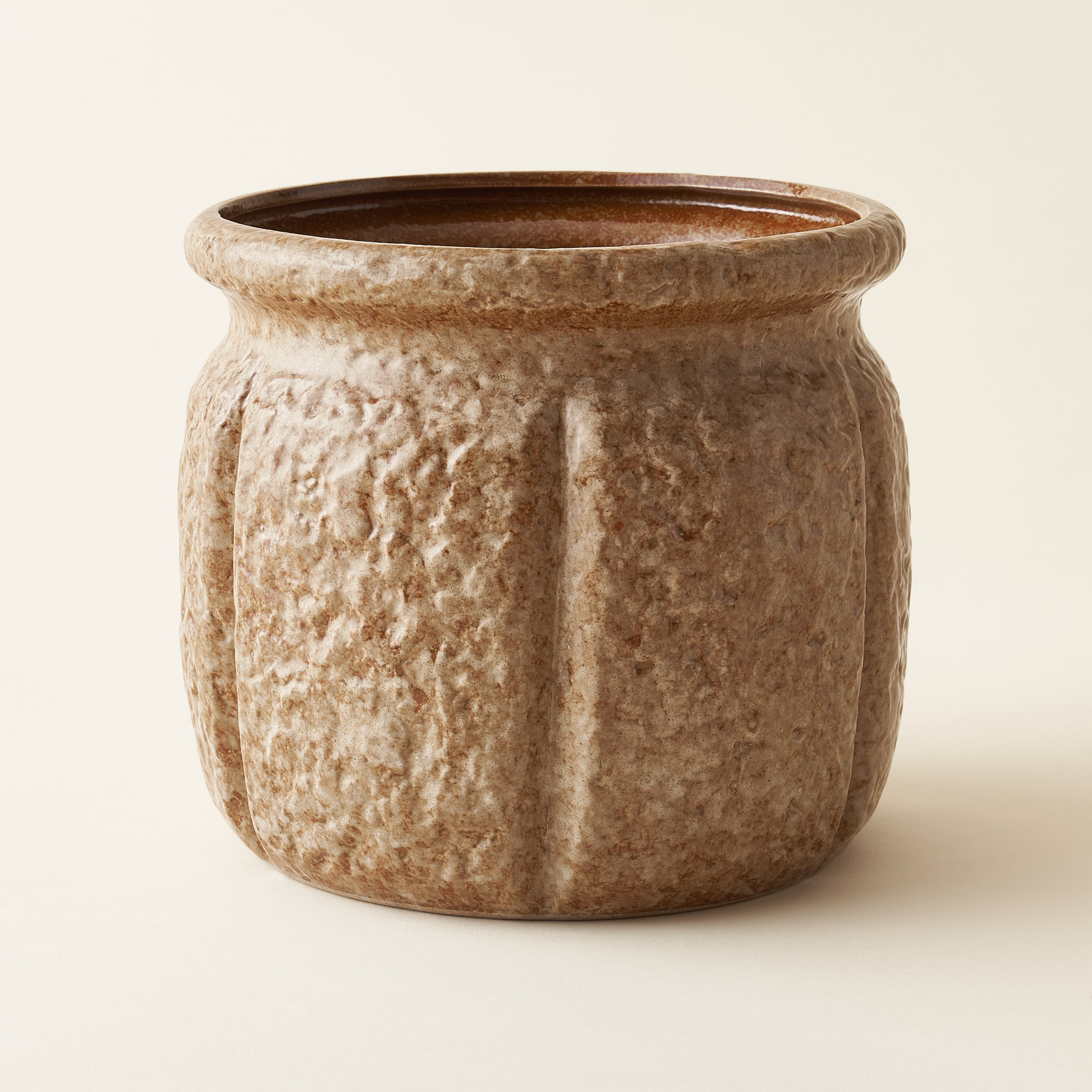 Sawyer planter, a 7-inch stoneware pot holder with a unique, textured finish.